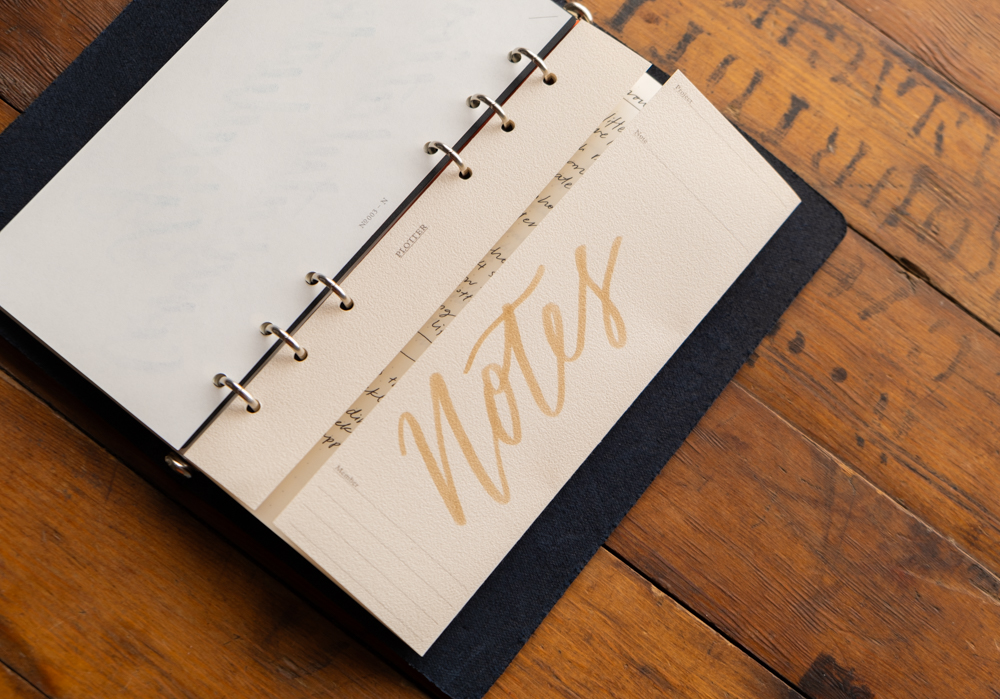Project Manager folder titled " Notes" inside of a PLOTTER leather binder.