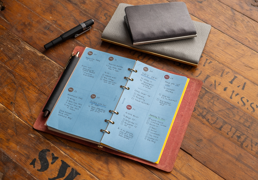 Blue Paper refill paper is used as weekly schedule inside a PLOTTER leather binder.