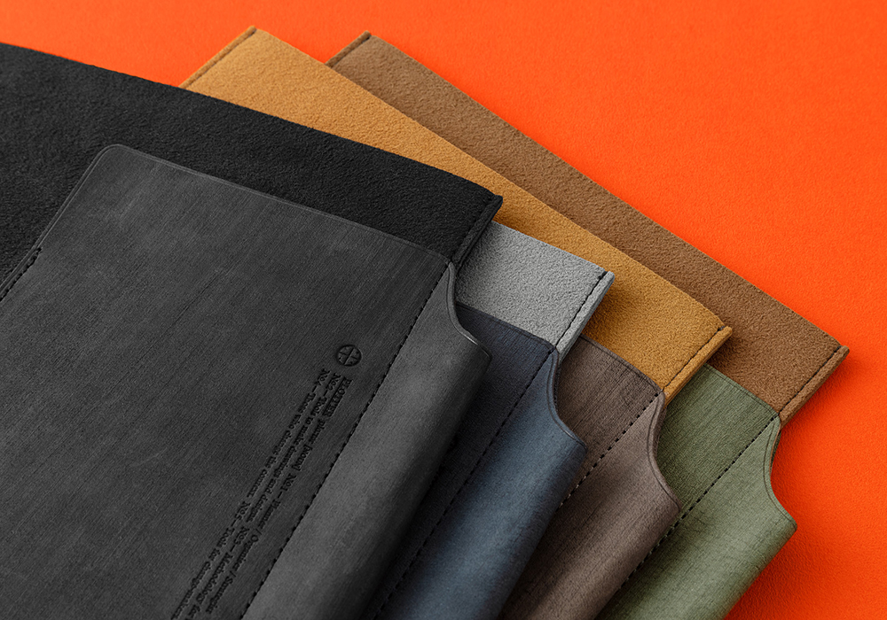Four color variations of PLOTTER Leather Binder Cases. 