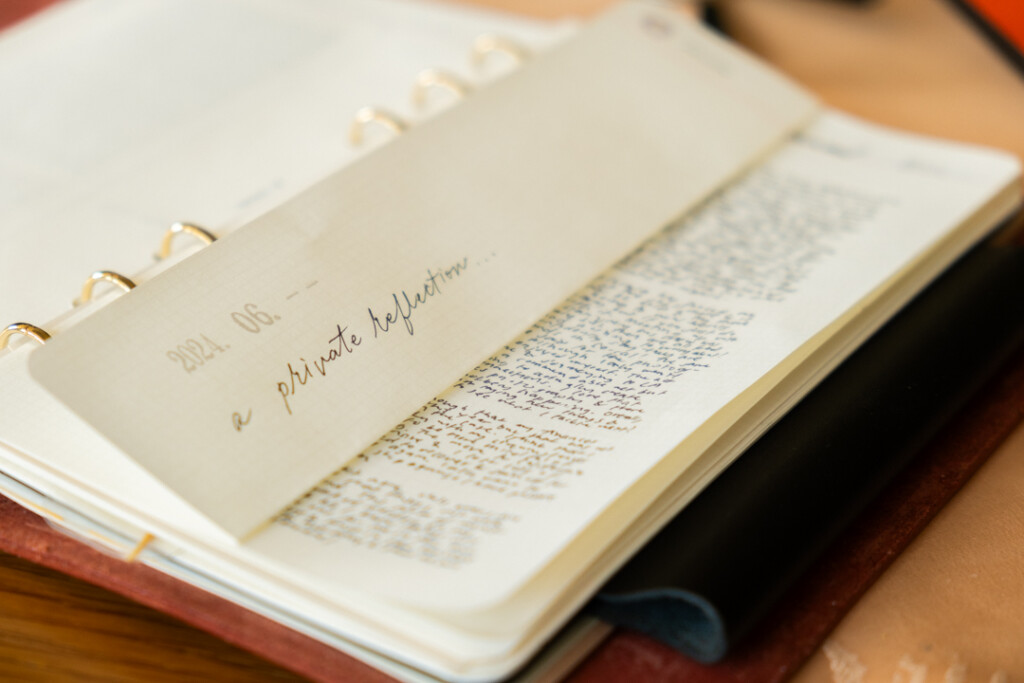 Close-up of PLOTTER Leather Binder open with a folded page.