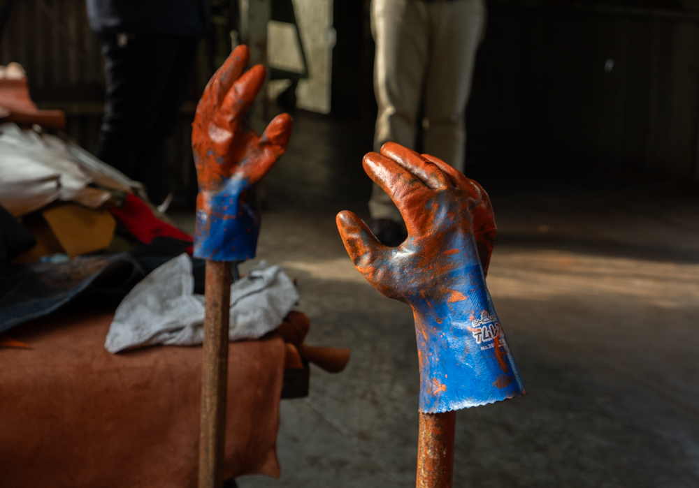 Blue gloves drying with orange dye on it.