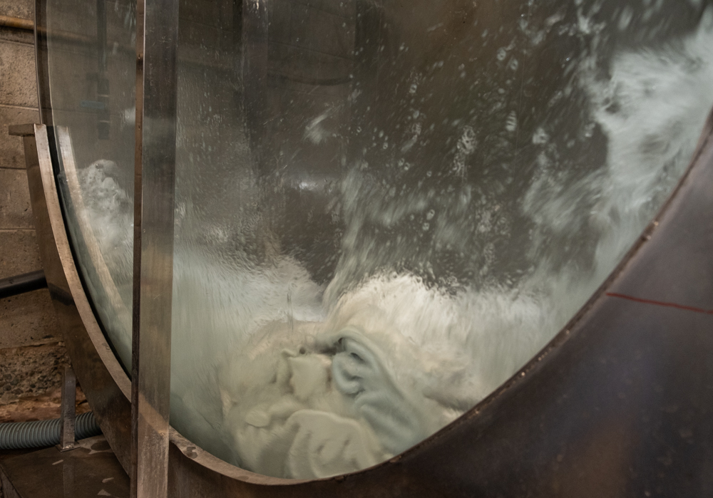 White leather being dyed in a tanning drum.