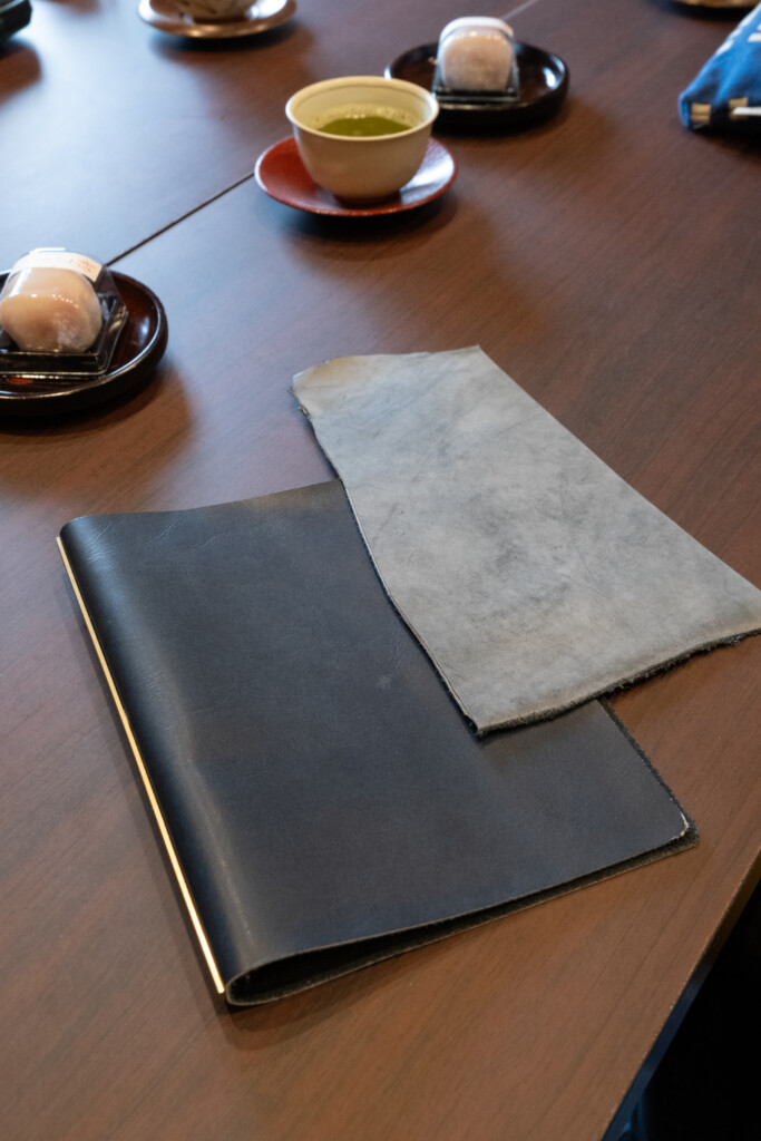 Prototype of Shiranami leather that is darker and does not have wax compared to the final version of Shiranami leather that has indigo dye and white wax.