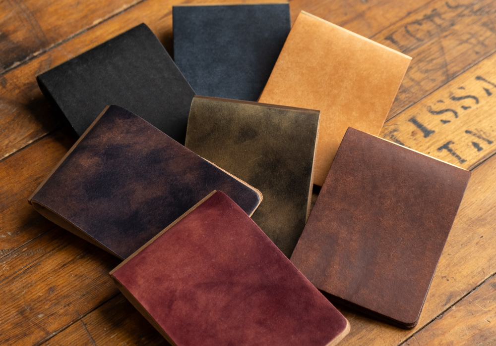 Seven 3-Ring Leather Binders in Pueblo and Unevenly Dyed Cordovan.