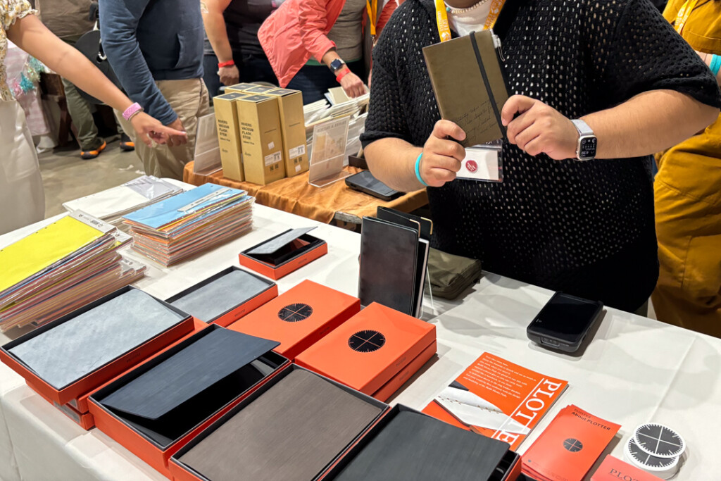 PLOTTER USA booth filled with Leather Binders at Stationery Fest with PLOTTER USA staff holding their PLOTTER Leather Binder.