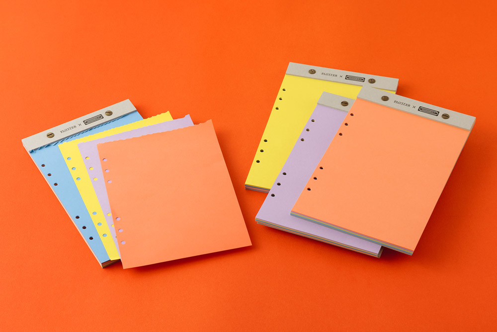 Four 6-Ring Desktop Color Memo Pad laid out against an orange background.