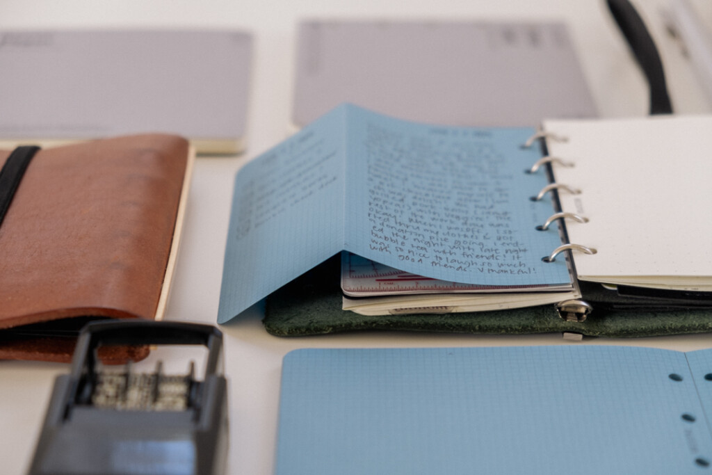 Mini 5 Square refills in Blue Paper unfolded to show that it extends past the PLOTTER Mini 5 Leather Binder.