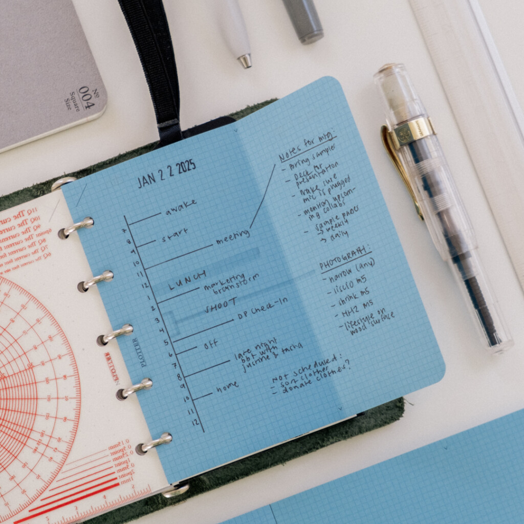 Mini 5 Square refills in Blue Paper unfolded to show that it extends past the PLOTTER Mini 5 Leather Binder, allowing more room to draw a vertical daily schedule.