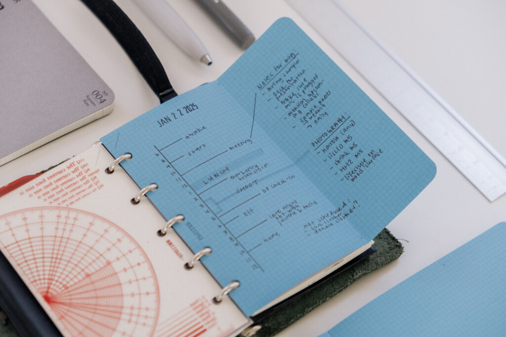 Mini 5 Square refills in Blue Paper unfolded to show that it extends past the PLOTTER Mini 5 Leather Binder, allowing more room to draw a vertical daily schedule.