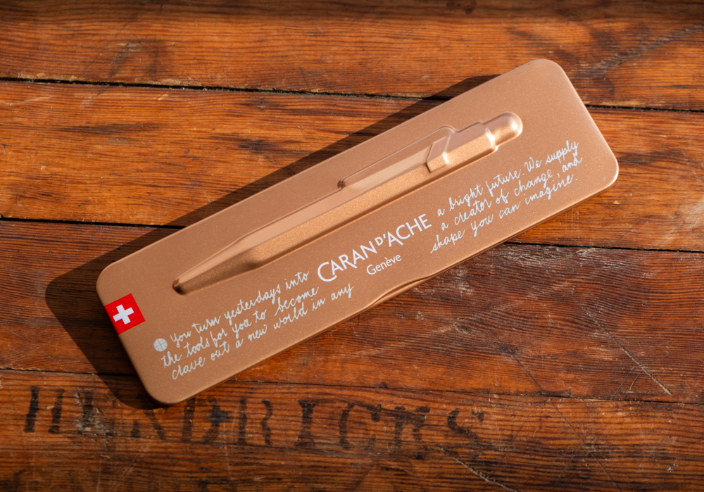 The metal case of a CARAN D'ACHE 849 ballpoint with PLOTTER manifesto printed on it.