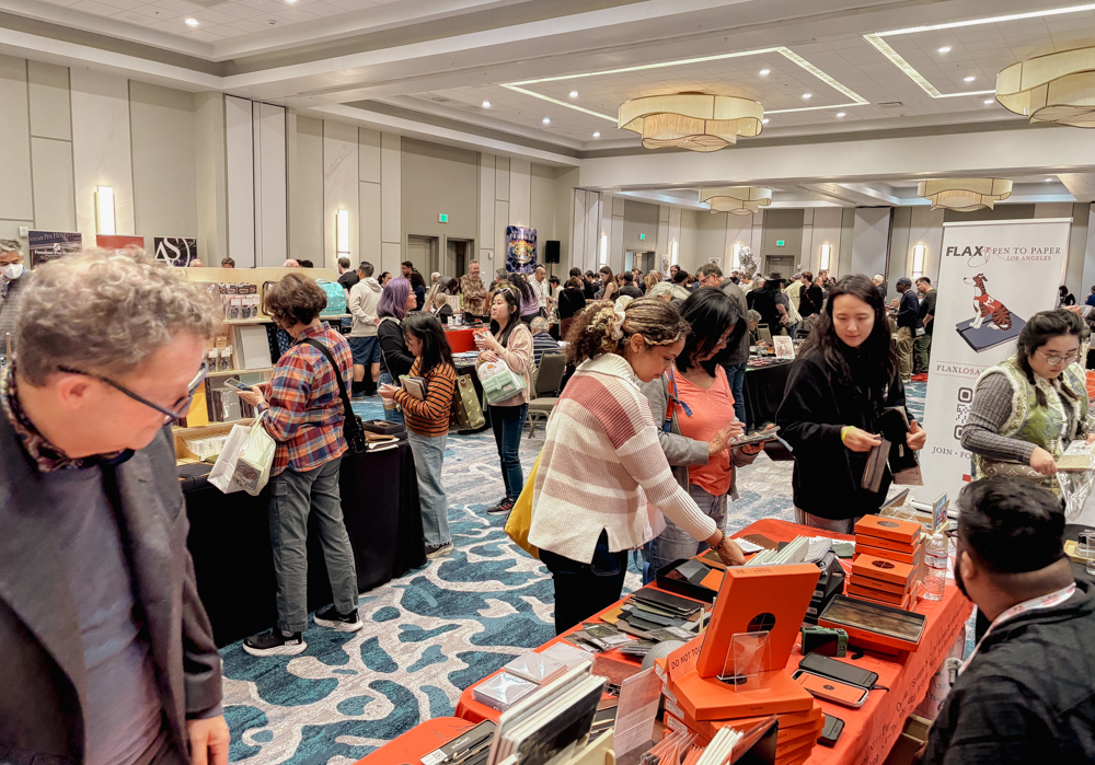 Attendees checking the PLOTTER USA table at the California Pen Show.