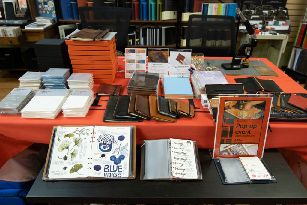 The PLOTTER display at Dromgoole's Fine Writing Instruments store filled with sample leather binders and other event-limited items.