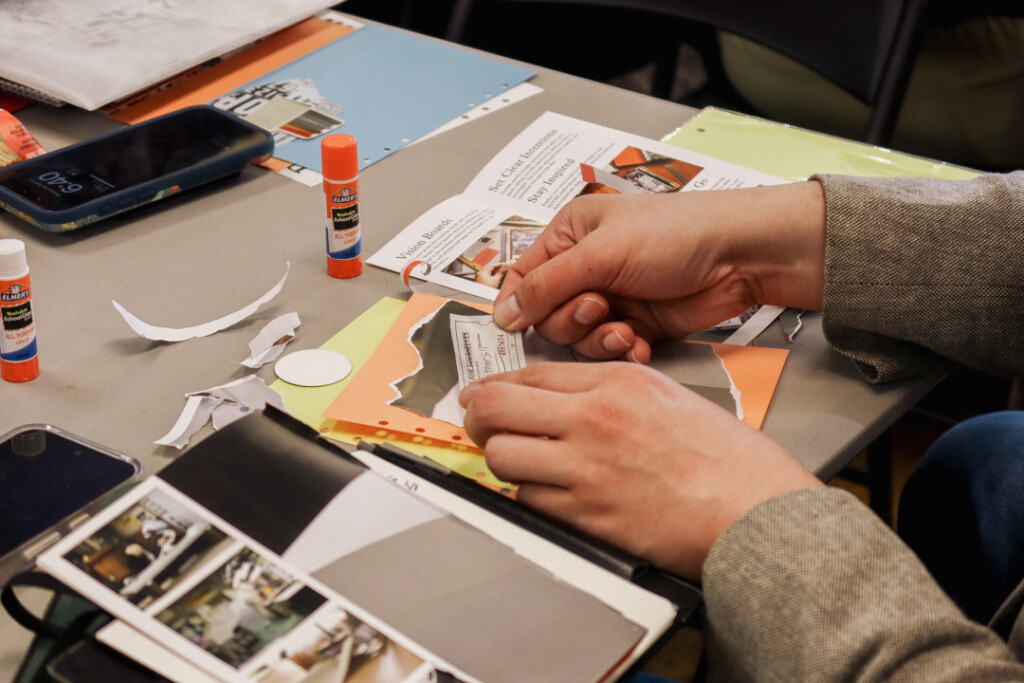 A student who attended the PLOTTER workshop working on their collage vision board.