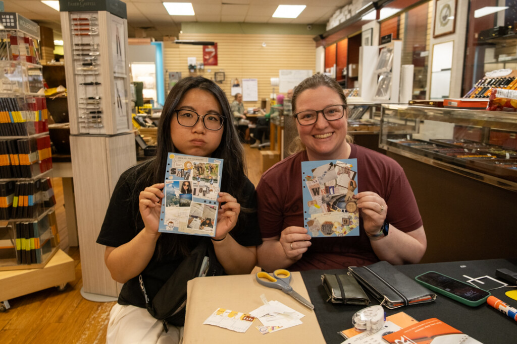 Two students who attended the PLOTTER workshop holding their completed vision boards.