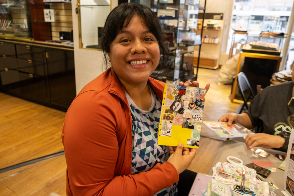 A student who attended the PLOTTER workshop holding their completed vision board.