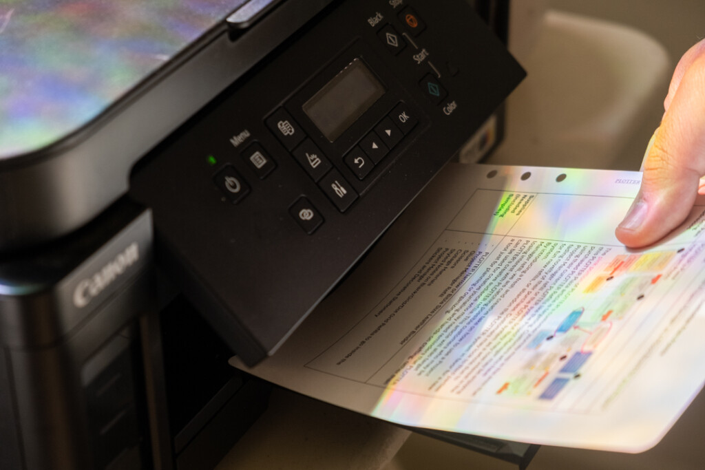 A printed sheet of paper coming out of a printer.