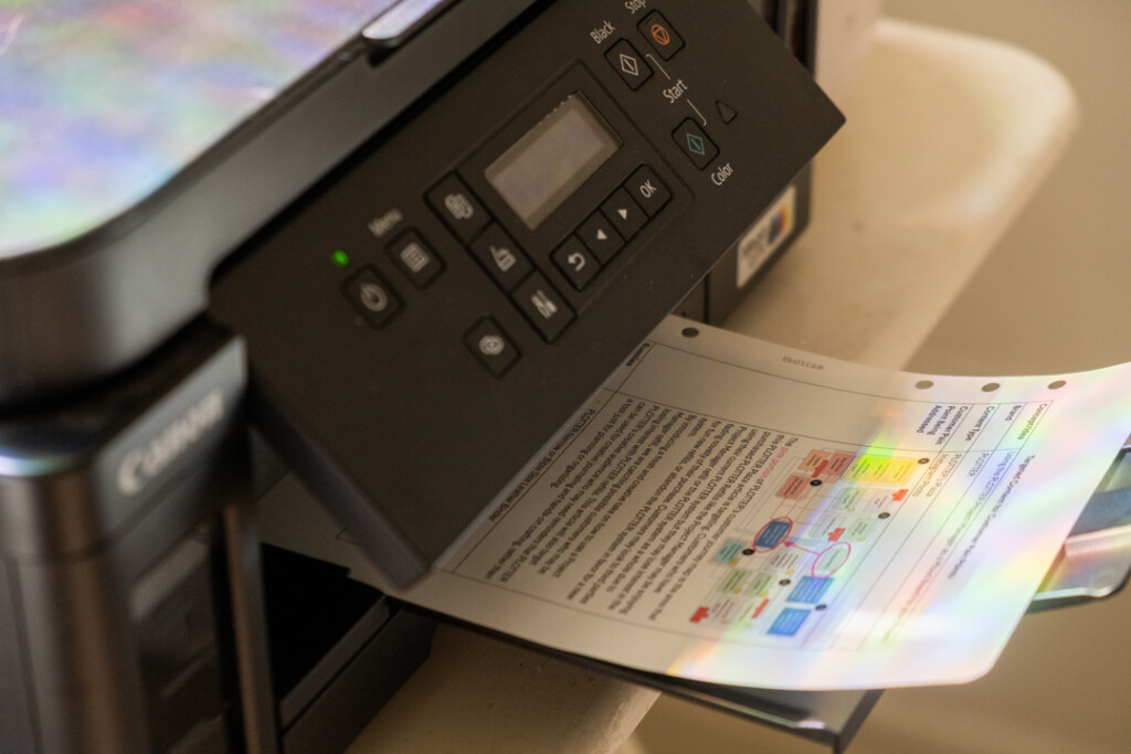 A printed sheet of paper coming out of a printer.